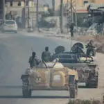 Syrian rebels sweep into Aleppo, army closes airport and roads